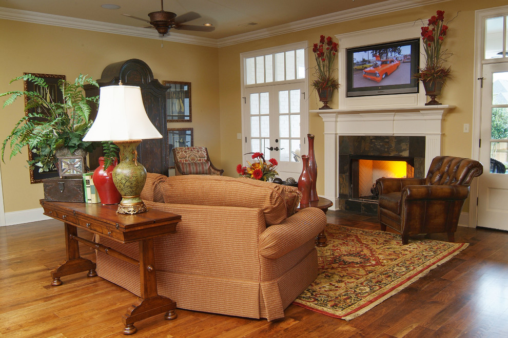 Design ideas for a medium sized traditional open plan games room in Nashville with beige walls, a standard fireplace, a tiled fireplace surround, a wall mounted tv and dark hardwood flooring.