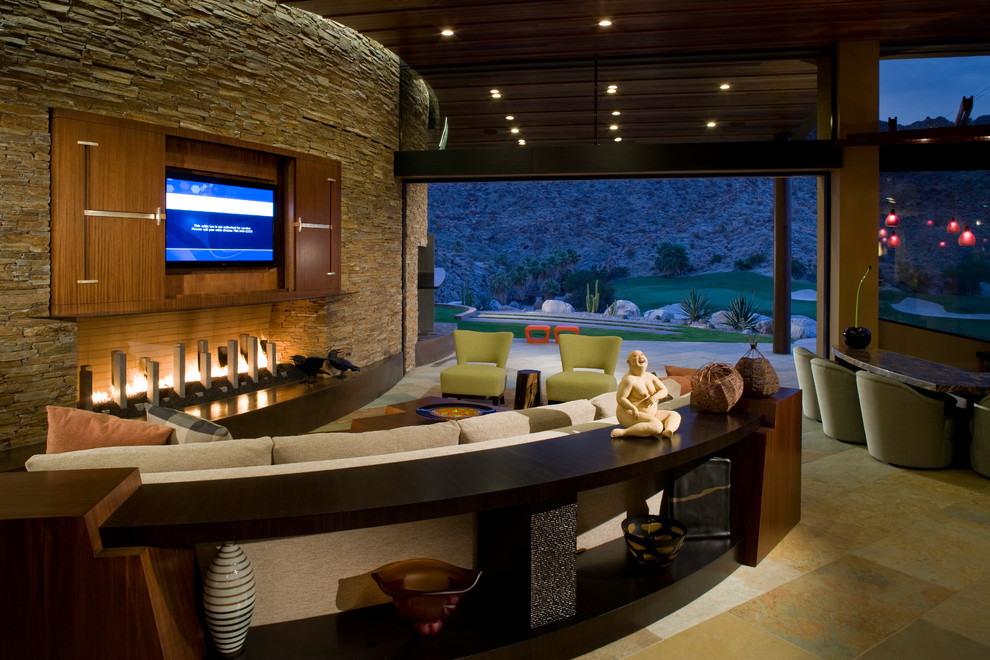 Family room - transitional open concept family room idea in Los Angeles with a ribbon fireplace, a stone fireplace and a concealed tv