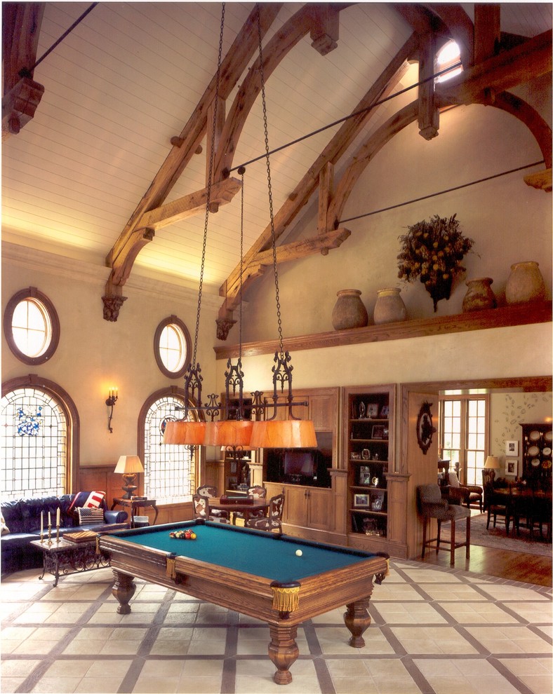 Ejemplo de sala de juegos en casa tradicional extra grande con paredes beige y todas las chimeneas