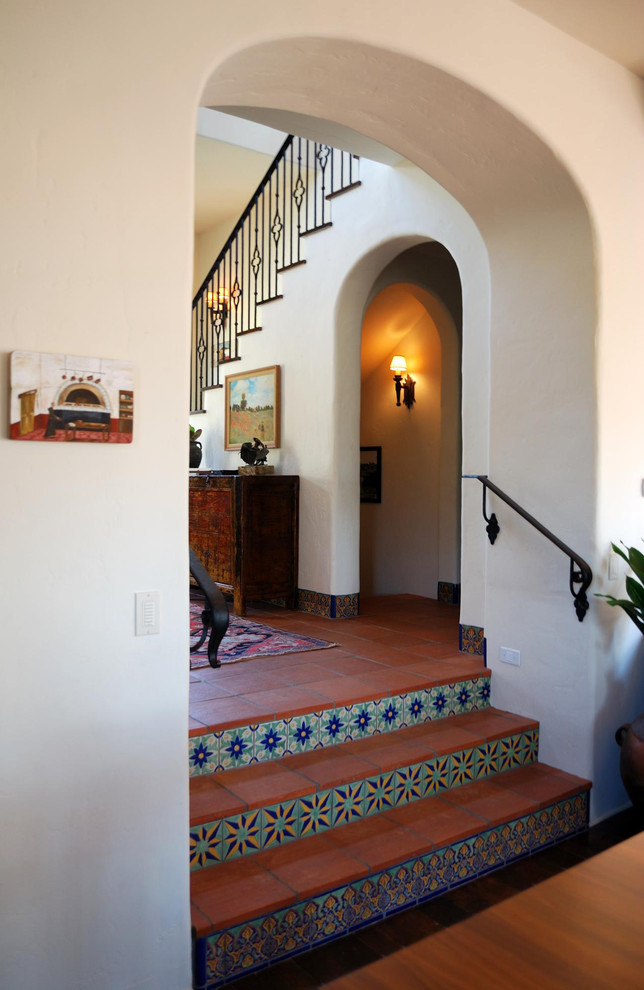 Inspiration for a mediterranean games room in San Diego with white walls and terracotta flooring.