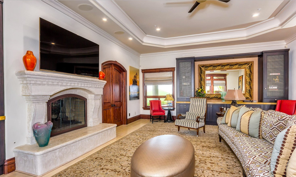 Expansive classic open plan games room in San Francisco with a game room, beige walls, light hardwood flooring, a two-sided fireplace, a plastered fireplace surround and a wall mounted tv.