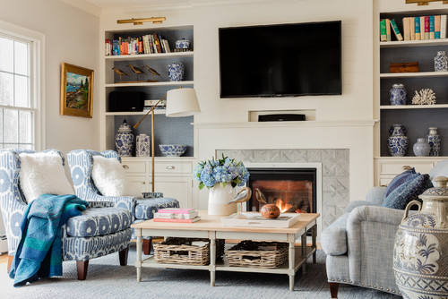 family room in Boston featuring a standard fireplace and a wall-mounted tv 