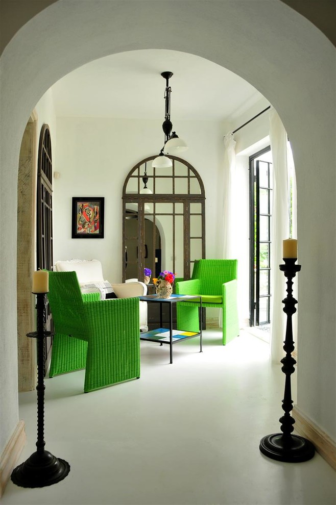 This is an example of a small mediterranean games room in Other with white walls.
