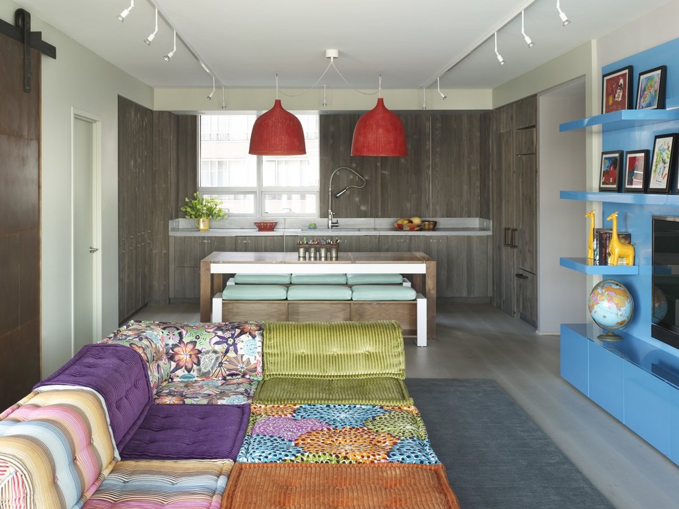 Example of an eclectic family room design in New York with beige walls and a media wall