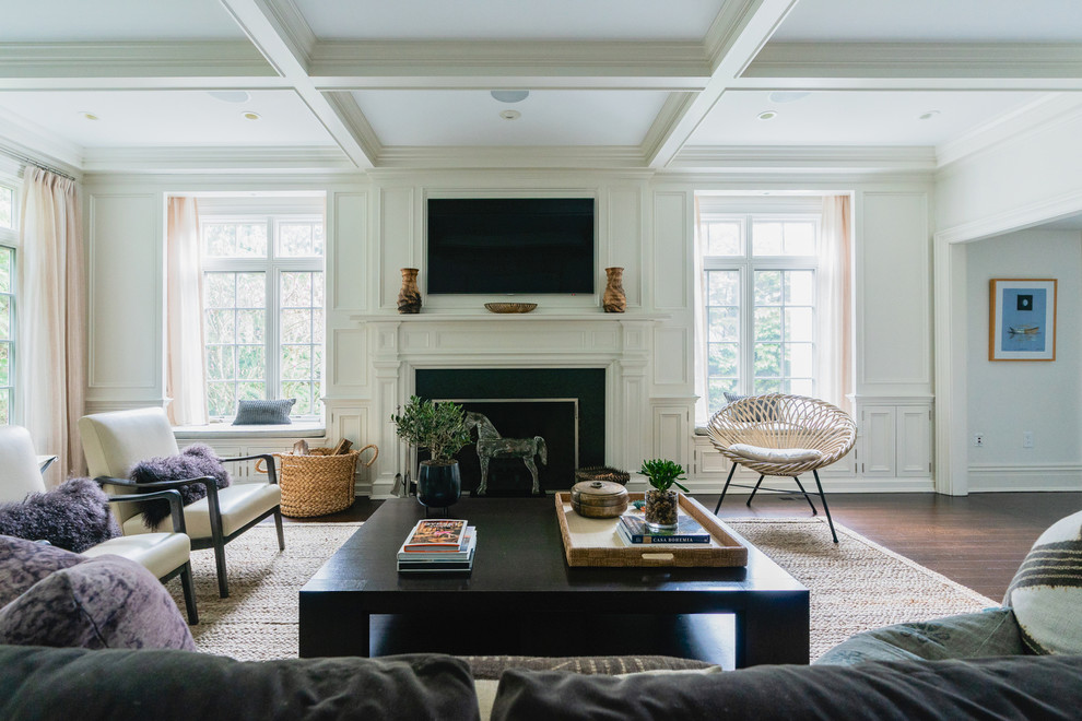Inspiration for a mid-sized eclectic enclosed dark wood floor and brown floor family room remodel in New York with white walls, a standard fireplace and a wood fireplace surround