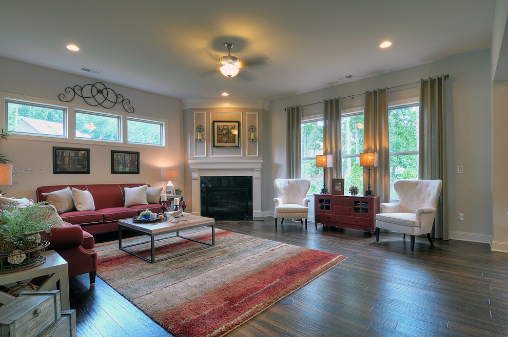 Trendy medium tone wood floor family room photo in Charlotte with beige walls and a corner fireplace