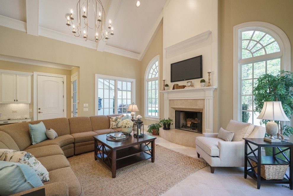 Family room - huge traditional open concept ceramic tile family room idea in Raleigh with beige walls, a standard fireplace, a stone fireplace and a wall-mounted tv