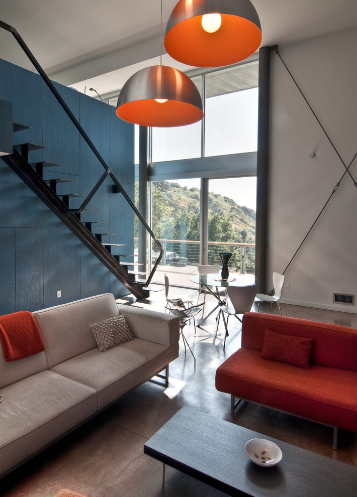 Immagine di un soggiorno design con pavimento in cemento