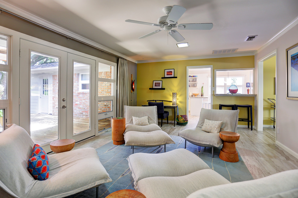 Mittelgroßes, Abgetrenntes Mid-Century Wohnzimmer ohne Kamin mit gelber Wandfarbe und Porzellan-Bodenfliesen in Houston
