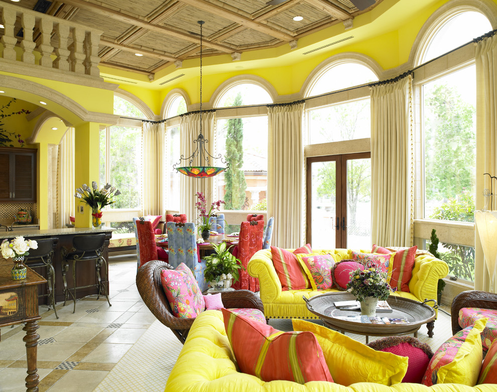 Example of a tuscan open concept family room design in Tampa with yellow walls