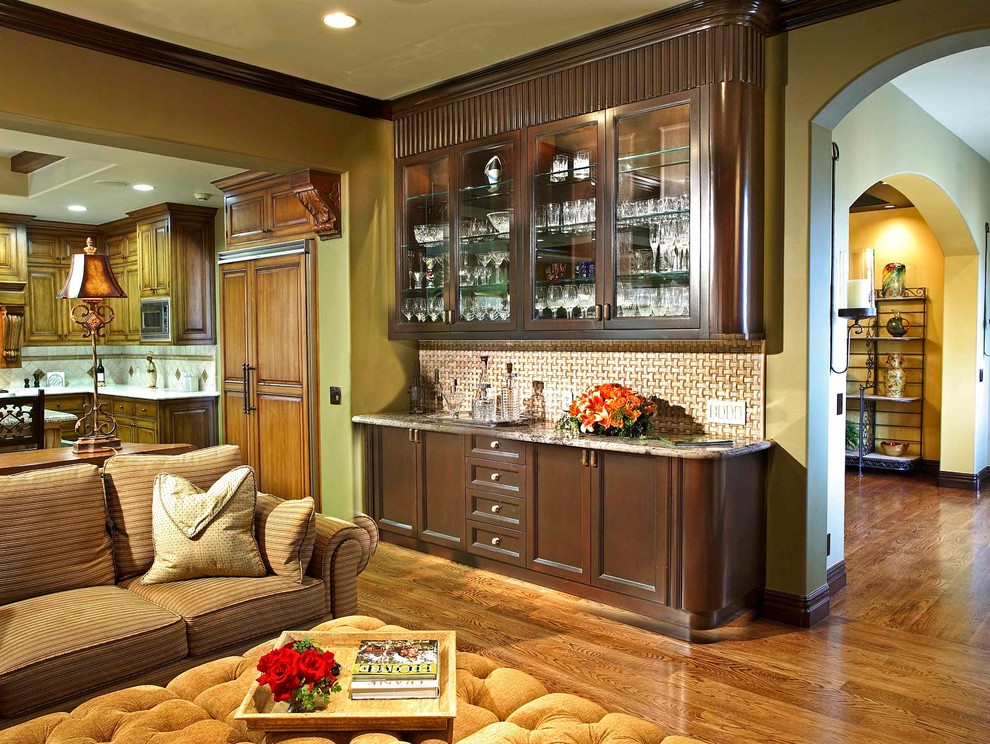 Large tuscan open concept medium tone wood floor family room photo in Los Angeles with a bar and green walls