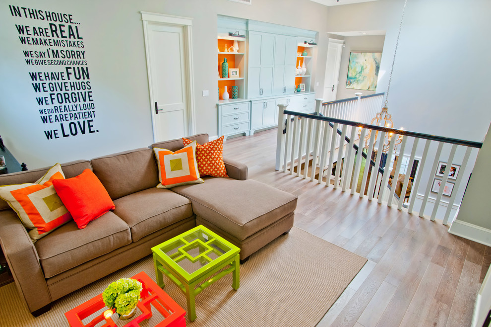 Elegant loft-style light wood floor and beige floor family room photo in Los Angeles with gray walls