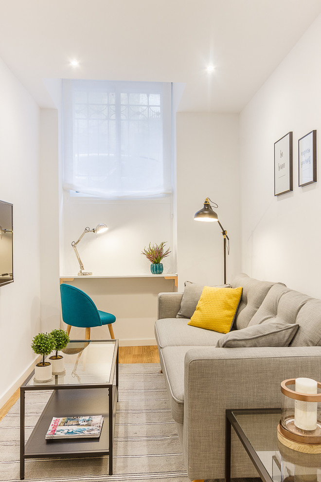 Example of a small danish family room design in Madrid with white walls, no fireplace and a wall-mounted tv
