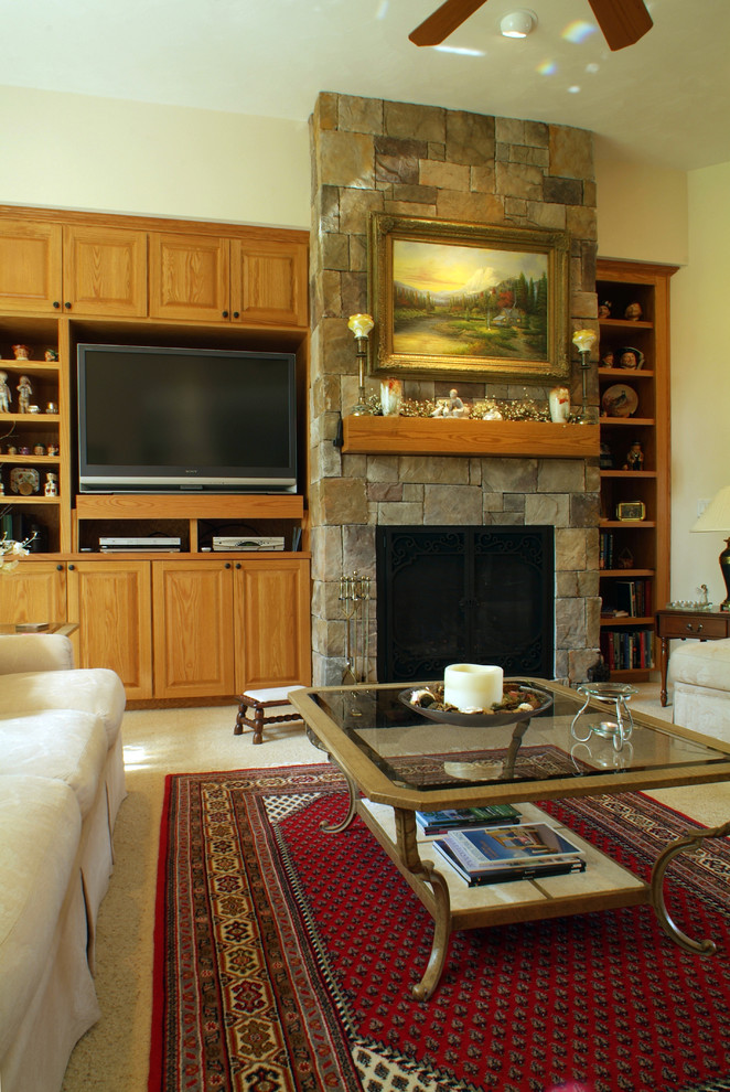 Example of a large transitional carpeted family room design in Other with a stone fireplace, a media wall, a standard fireplace and beige walls