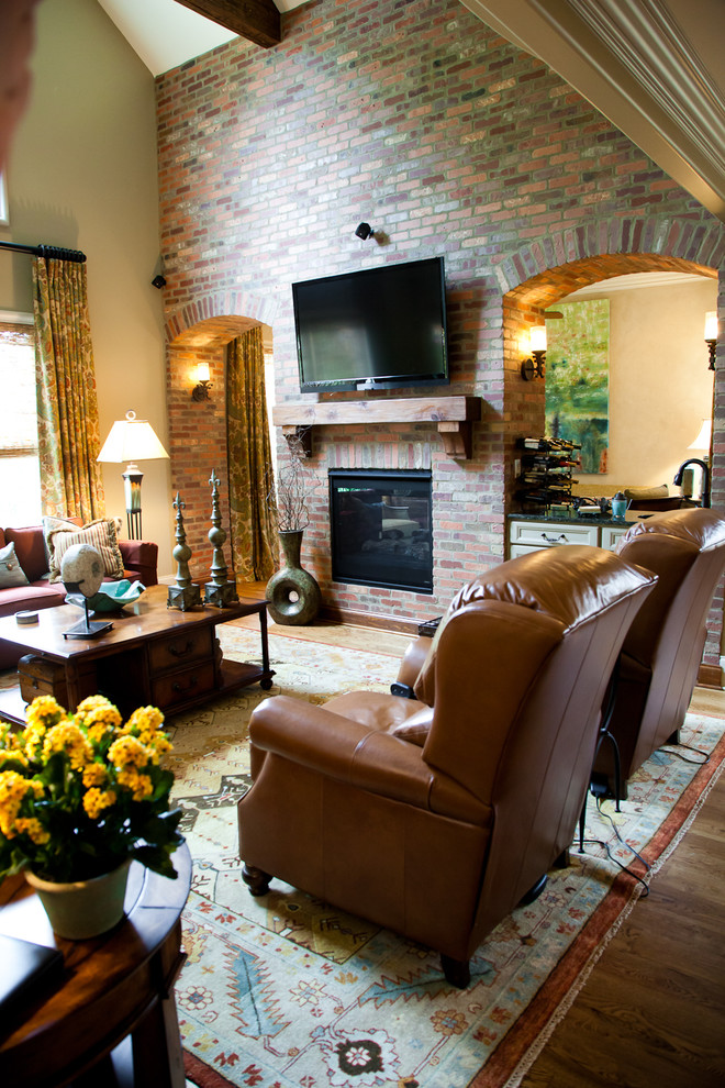 Inspiration for a large eclectic family room remodel in Other with a two-sided fireplace, a brick fireplace and a wall-mounted tv
