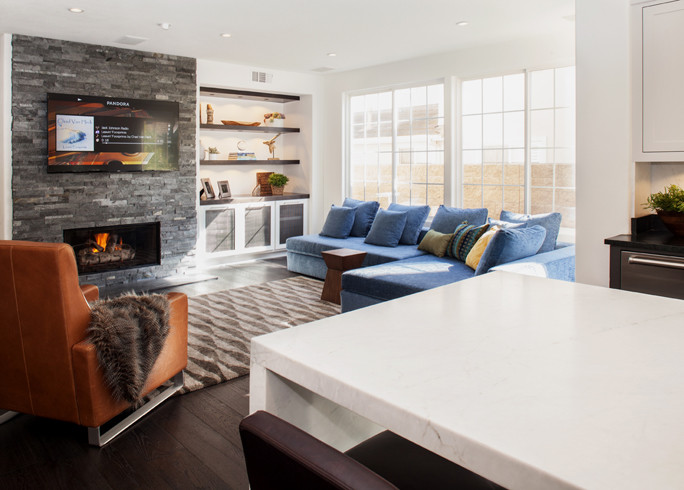 Inspiration for a medium sized contemporary open plan games room in Orange County with white walls, dark hardwood flooring, a ribbon fireplace, a stone fireplace surround and a wall mounted tv.