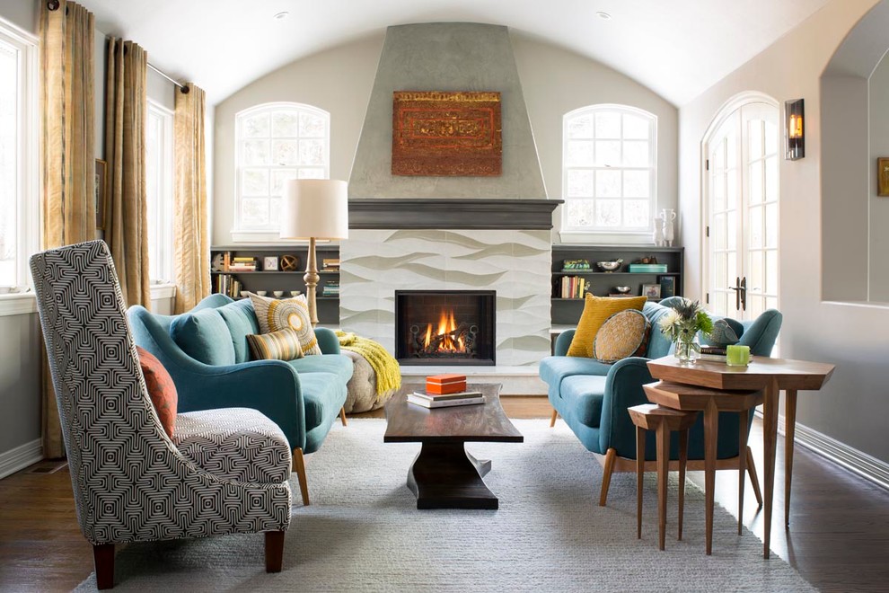 Family room - eclectic medium tone wood floor family room idea in Denver with gray walls and a stone fireplace