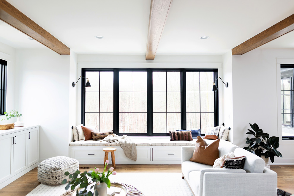 Foto di un grande soggiorno design aperto con pareti bianche e pavimento in legno massello medio