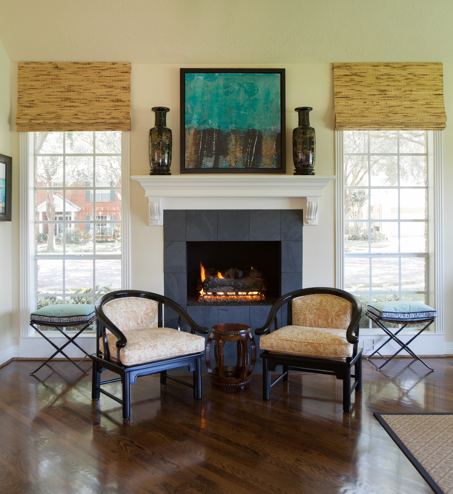 Foto de sala de estar tradicional con paredes beige, suelo de madera oscura, todas las chimeneas y marco de chimenea de baldosas y/o azulejos