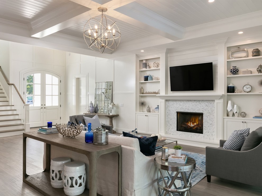 Medium sized nautical open plan games room in Orlando with white walls, a tiled fireplace surround, a wall mounted tv, light hardwood flooring, a standard fireplace and brown floors.