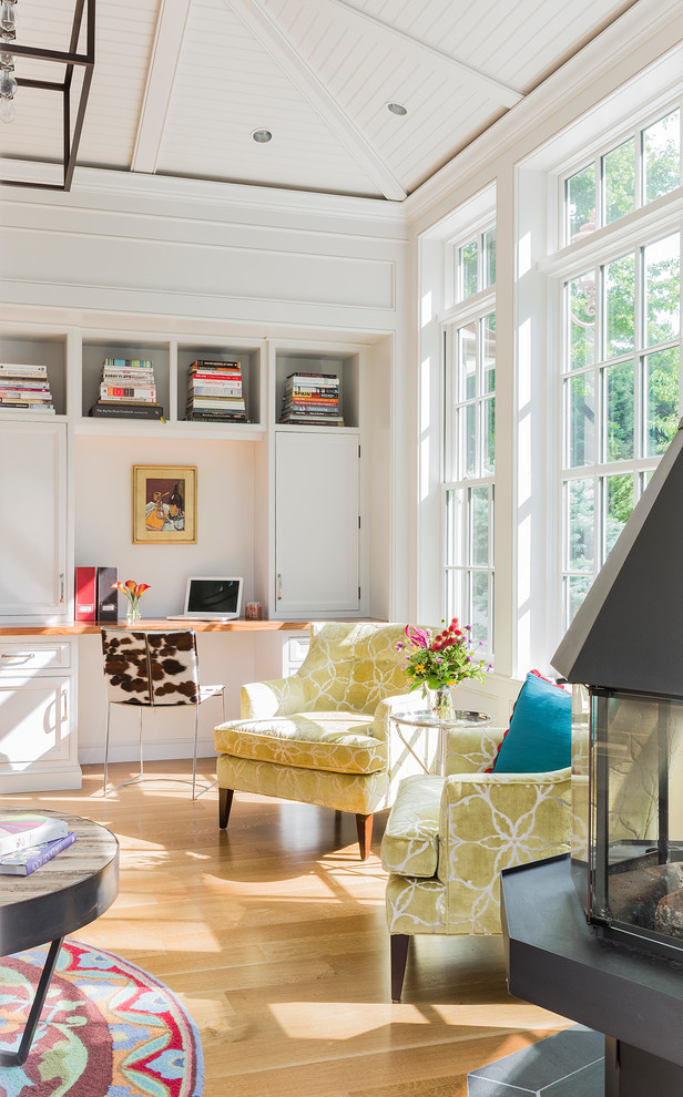 Foto de sala de estar contemporánea de tamaño medio con paredes blancas, suelo de madera en tonos medios, chimeneas suspendidas y marco de chimenea de piedra