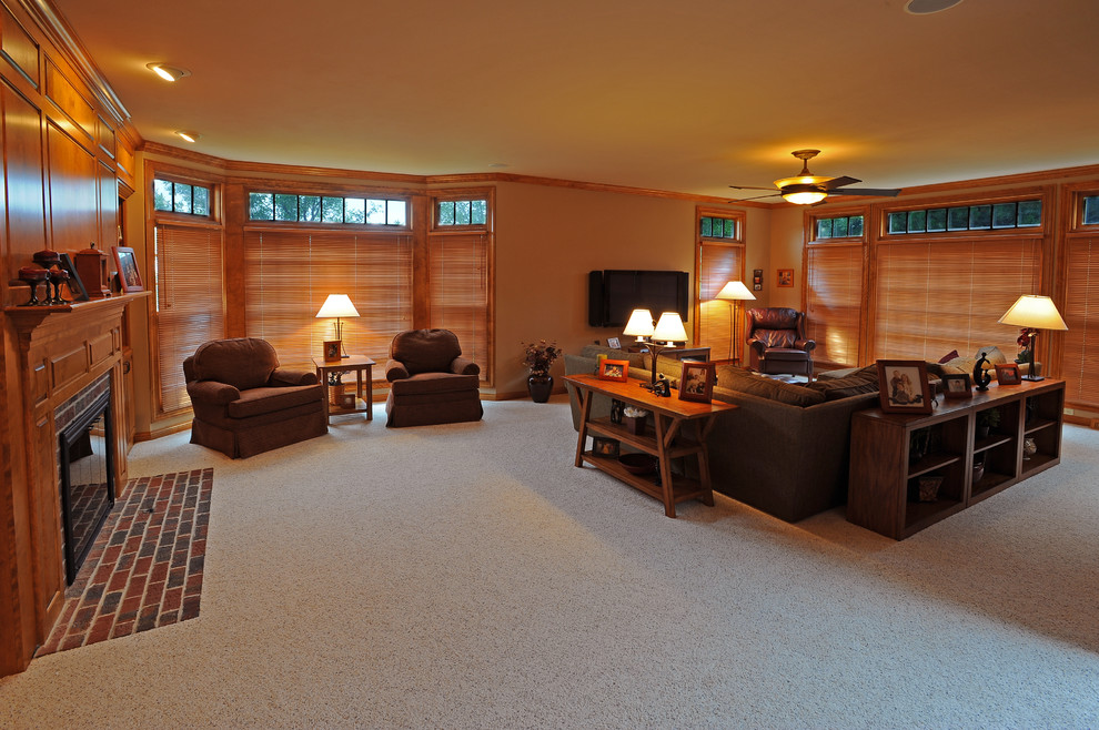 Large elegant enclosed carpeted family room photo in Milwaukee with brown walls, a standard fireplace, a brick fireplace and a wall-mounted tv