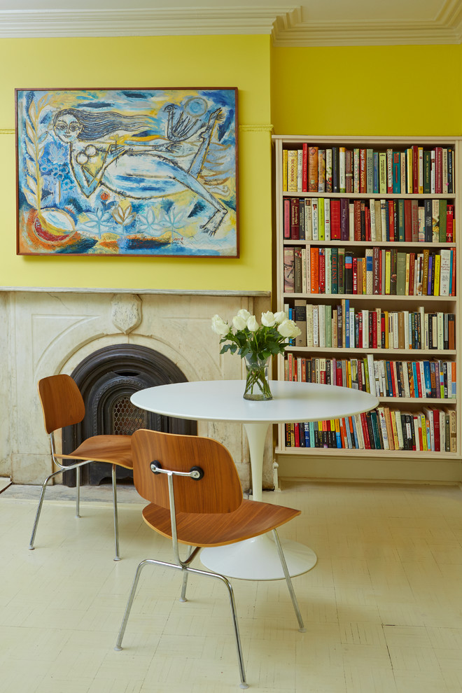 Inspiration for a transitional painted wood floor family room library remodel in New York with yellow walls, a standard fireplace and a stone fireplace
