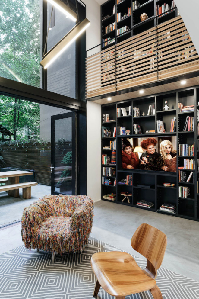Example of a large trendy loft-style wood wall family room design in New York with a media wall