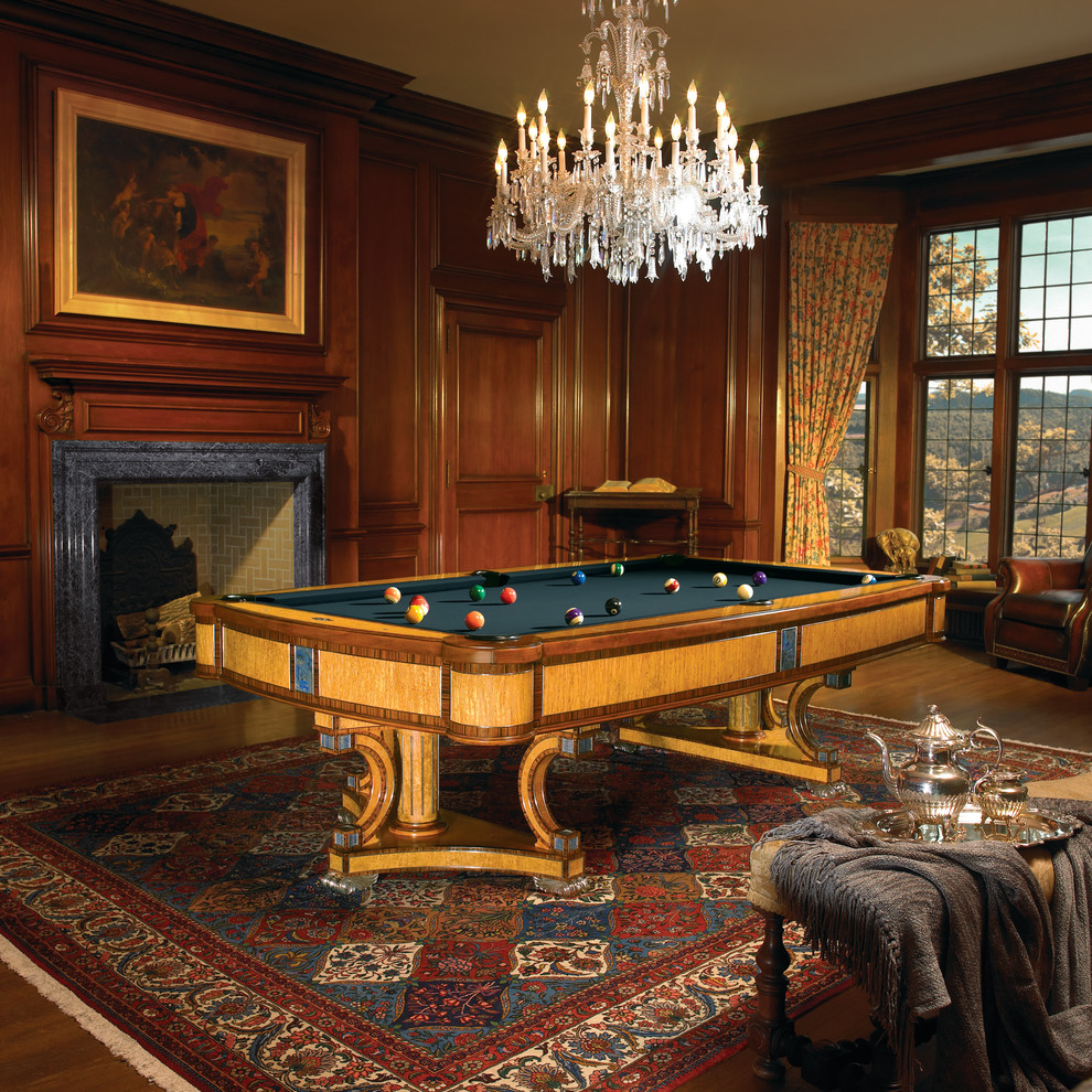 This is an example of a large victorian enclosed games room in Orange County with a game room, brown walls, medium hardwood flooring, a standard fireplace, a stone fireplace surround and no tv.