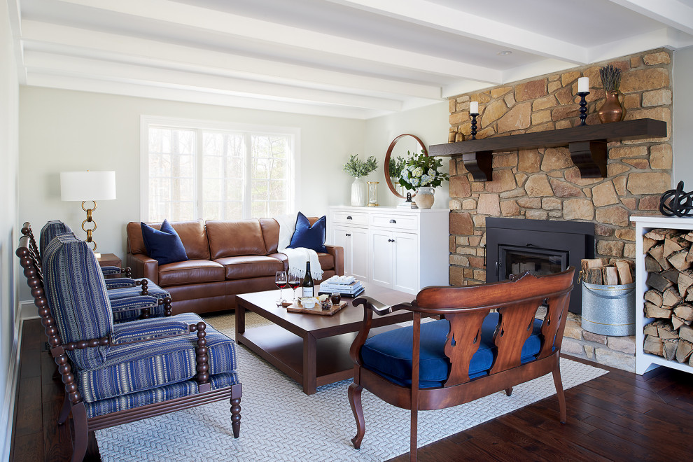 Inspiration for a mid-sized timeless enclosed dark wood floor, brown floor and exposed beam family room remodel in Philadelphia with gray walls, a standard fireplace, a stone fireplace and no tv