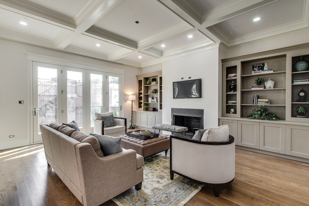 Large classic open plan games room in Chicago with beige walls, light hardwood flooring and a standard fireplace.