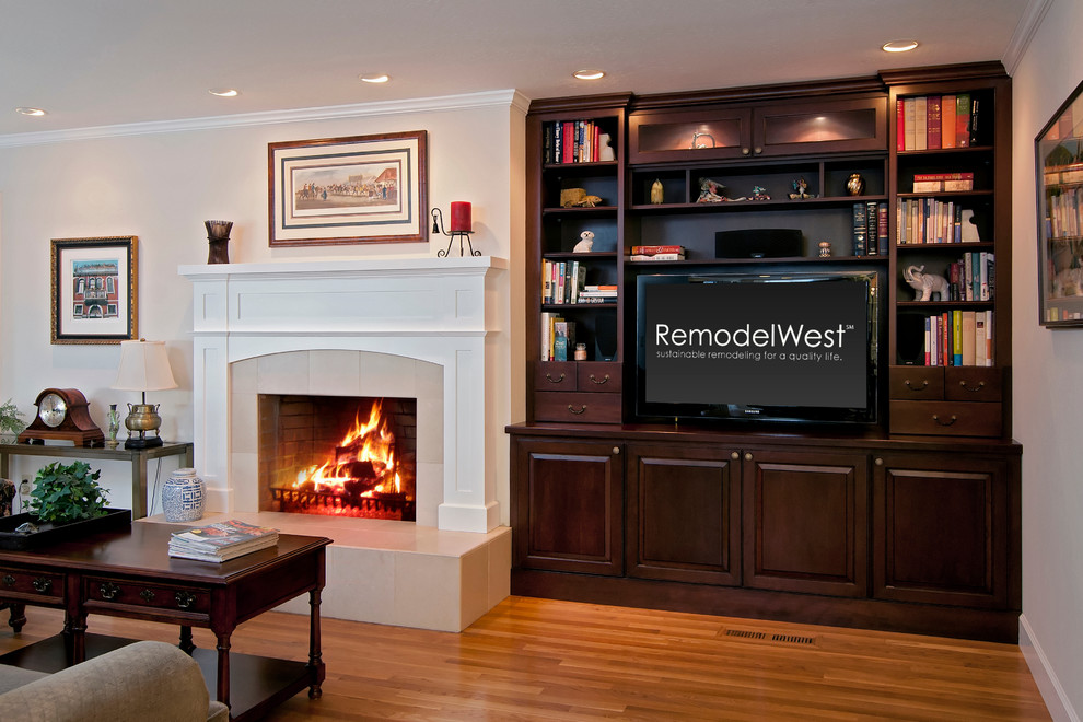 Traditional games room in San Francisco with a reading nook, light hardwood flooring, a standard fireplace, a stone fireplace surround and a built-in media unit.