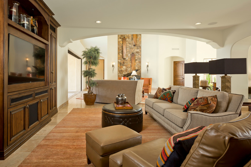 Inspiration for a large traditional enclosed games room in Phoenix with beige walls, travertine flooring, a two-sided fireplace, a stone fireplace surround and a built-in media unit.