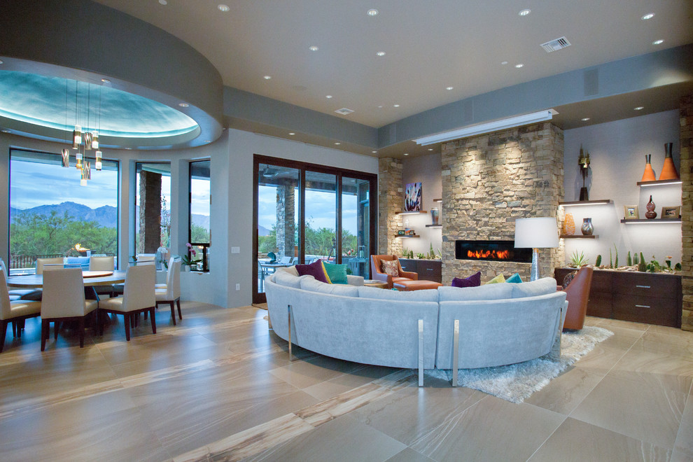 Стильный дизайн: открытая гостиная комната среднего размера в современном стиле с серыми стенами, фасадом камина из камня и бежевым полом - последний тренд