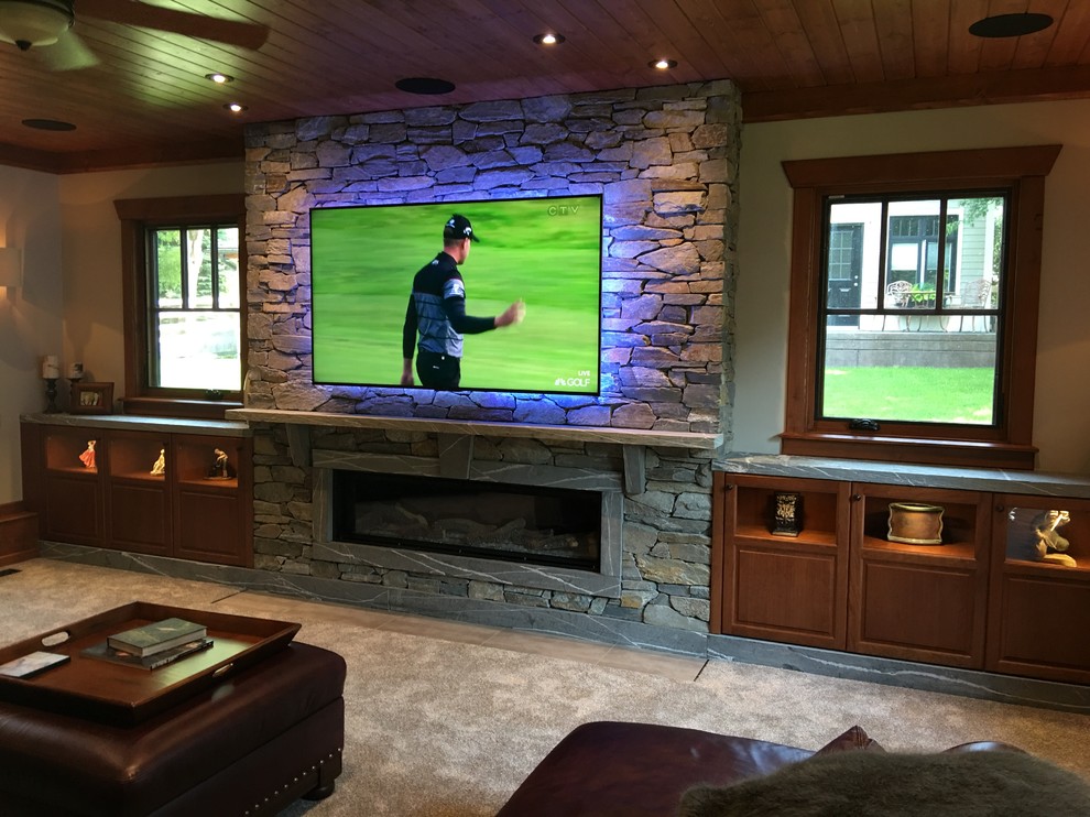 Design ideas for a large traditional enclosed games room in Other with a game room, brown walls, carpet, a ribbon fireplace, a stone fireplace surround and a wall mounted tv.