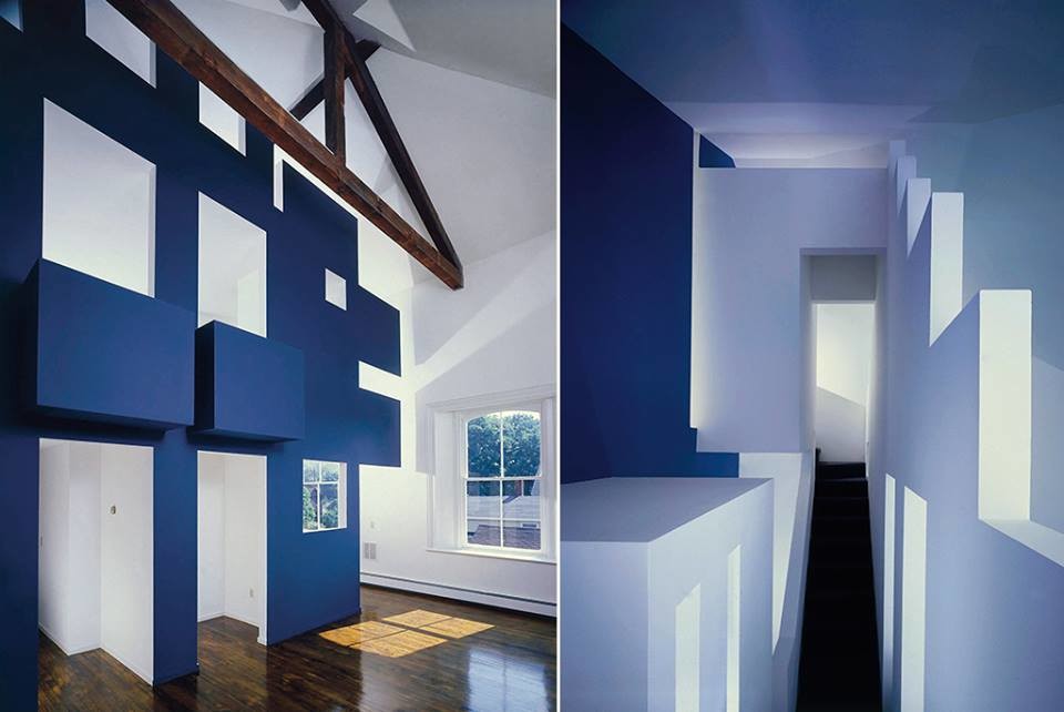 Large minimalist loft-style dark wood floor and brown floor family room photo in Providence with blue walls, a concealed tv, a corner fireplace and a plaster fireplace