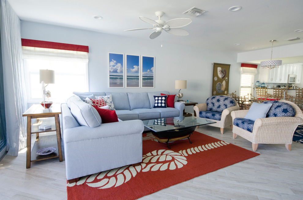 Immagine di un grande soggiorno costiero aperto con pareti blu, pavimento con piastrelle in ceramica e TV autoportante