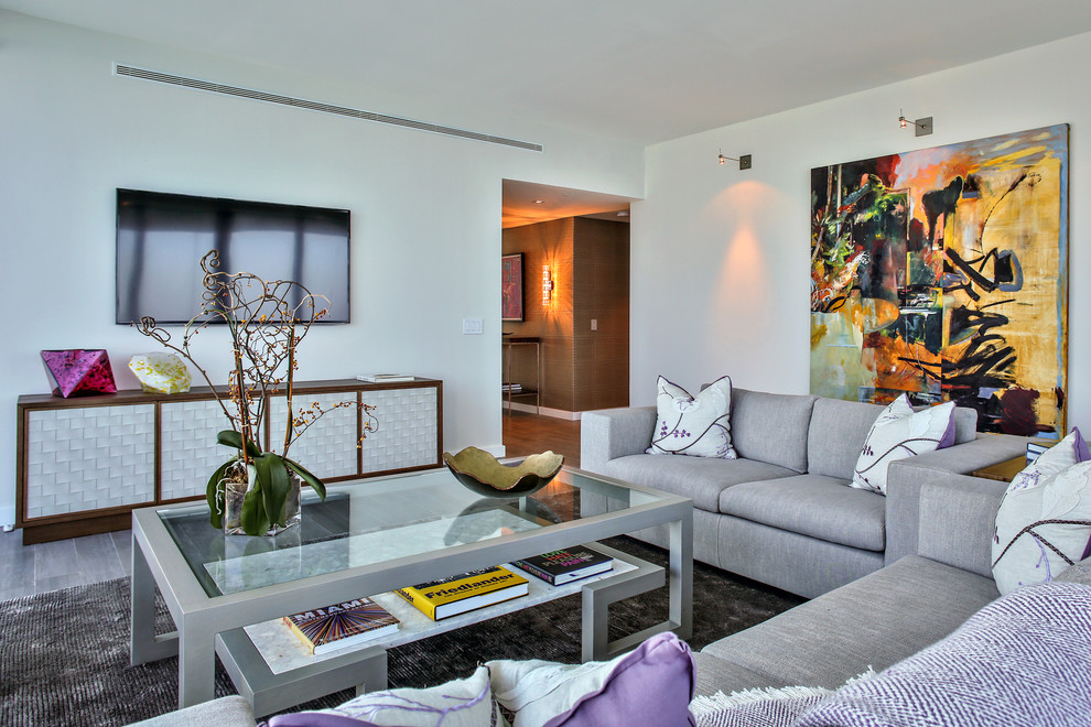 This is an example of a large contemporary enclosed games room in Miami with beige walls, a wall mounted tv and porcelain flooring.