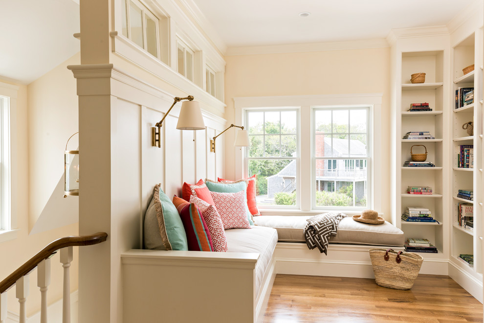 Small elegant loft-style medium tone wood floor and brown floor family room photo in Boston with beige walls, no fireplace and no tv