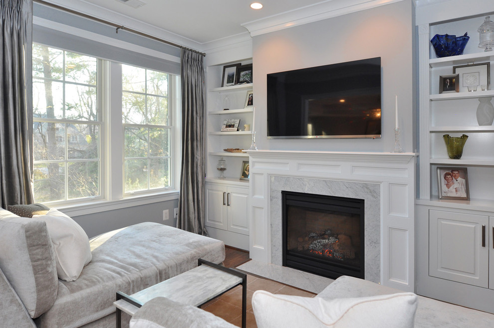 Inspiration for a timeless family room remodel in DC Metro with gray walls, a standard fireplace and a stone fireplace