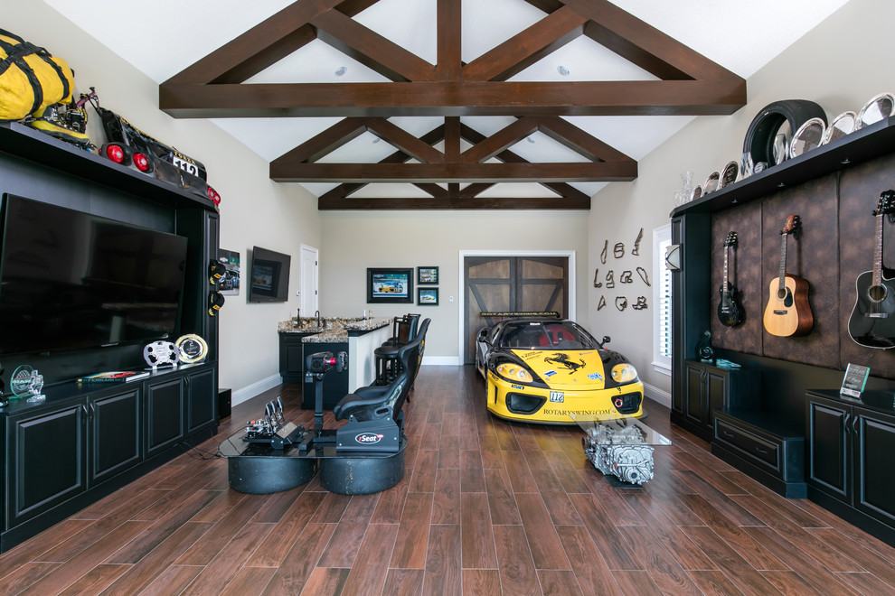 Huge tuscan dark wood floor game room photo in Orlando with beige walls, no fireplace and a wall-mounted tv