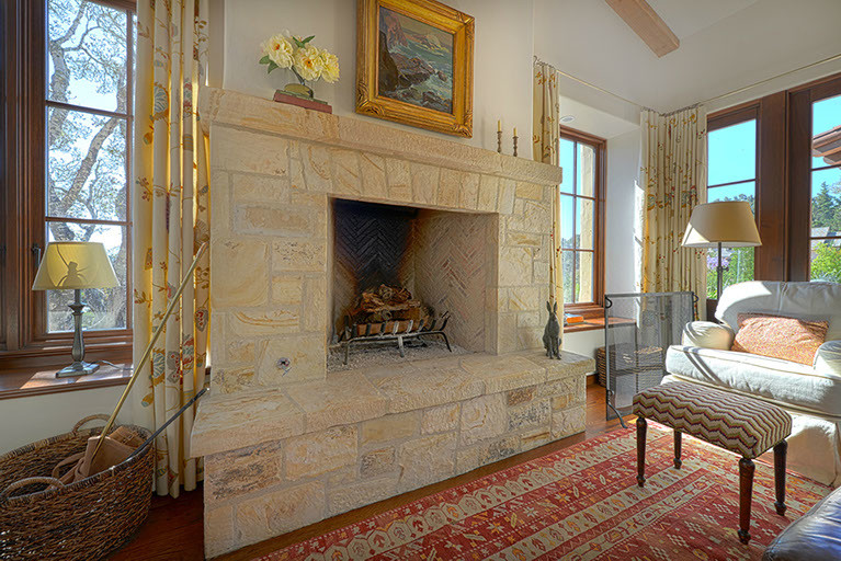 Example of an open concept medium tone wood floor family room design in Other with white walls, a standard fireplace and a stone fireplace