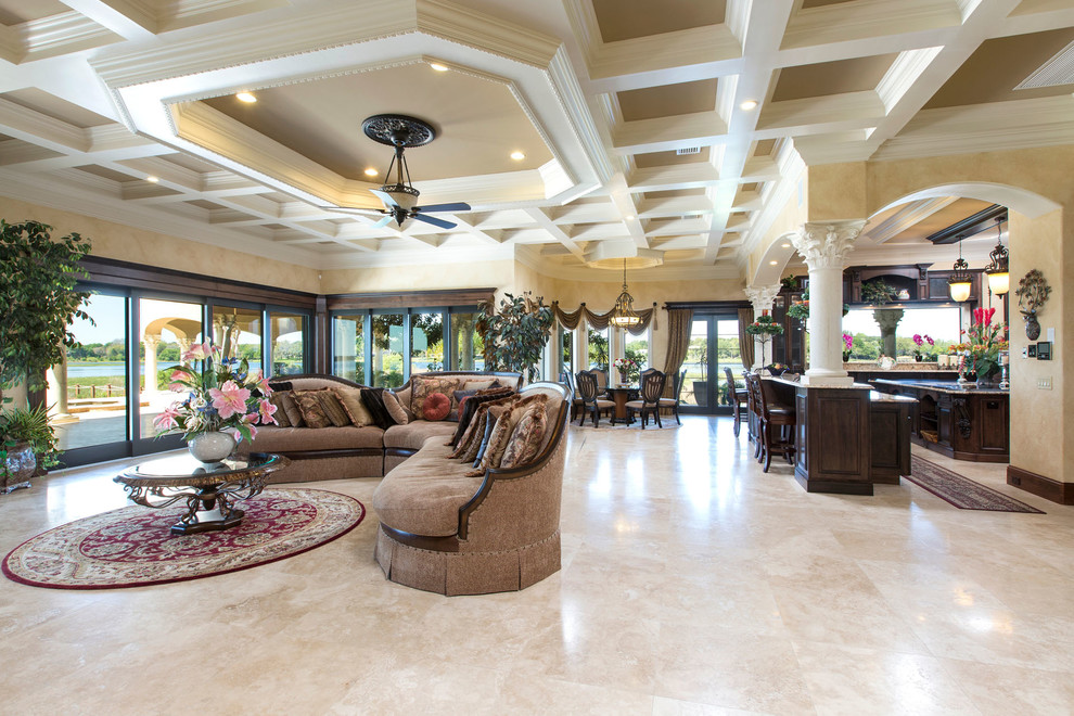 Photo of an expansive mediterranean open plan games room in Orlando with beige walls, travertine flooring and a built-in media unit.