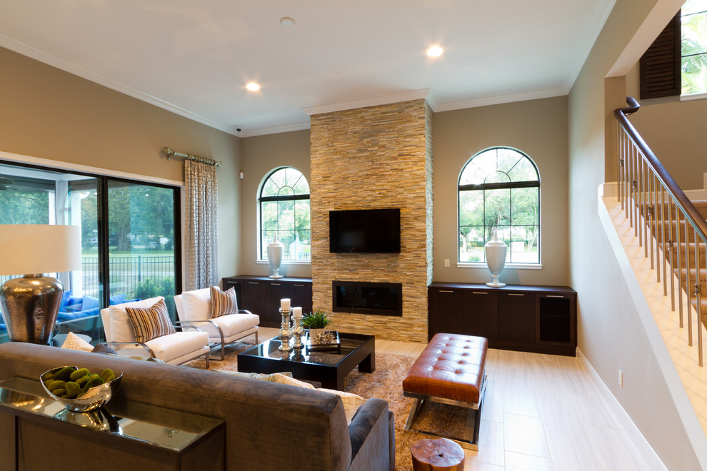 Photo of a large mediterranean open plan games room in Orlando with a home bar, brown walls, porcelain flooring, a ribbon fireplace, a stone fireplace surround and a wall mounted tv.