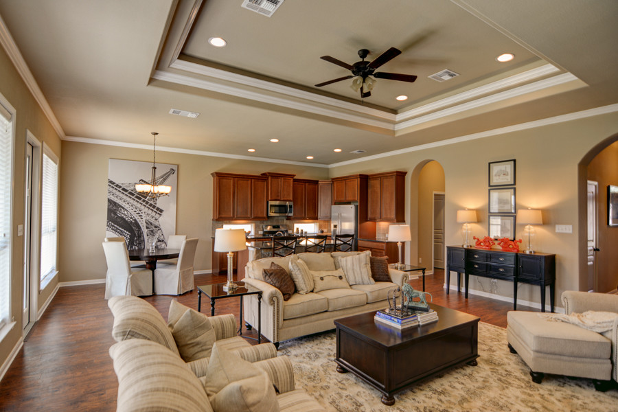This is an example of a large traditional open plan games room in Austin with beige walls, medium hardwood flooring, no fireplace and a built-in media unit.