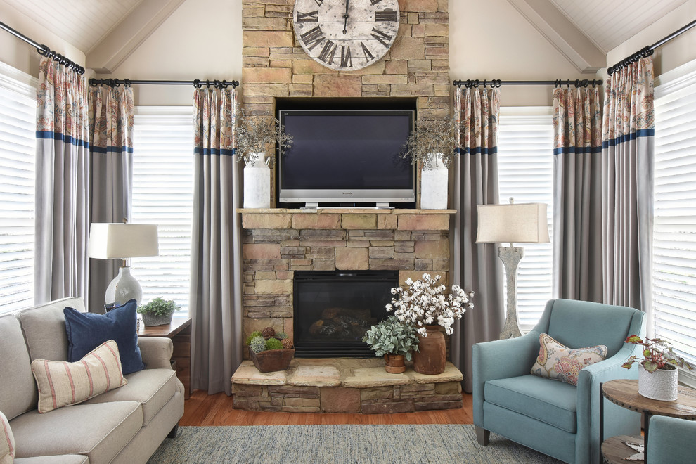 Photo of a classic games room in Atlanta with beige walls, medium hardwood flooring, a standard fireplace, a stone fireplace surround and a built-in media unit.