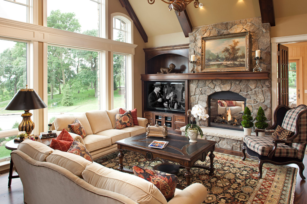 Example of a huge classic open concept dark wood floor family room design in Minneapolis with beige walls, a two-sided fireplace, a stone fireplace and a tv stand