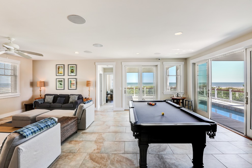 Medium sized beach style enclosed games room in New York with beige walls, porcelain flooring and beige floors.