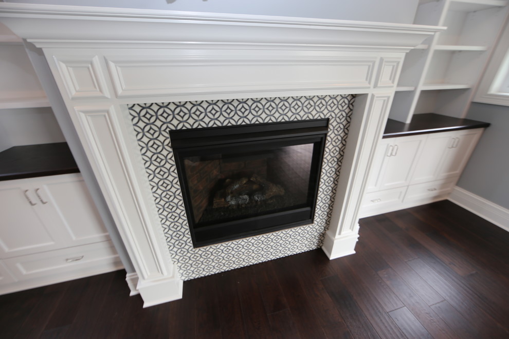 Example of a large arts and crafts open concept dark wood floor and brown floor family room design in Chicago with gray walls, a standard fireplace, a tile fireplace and a wall-mounted tv