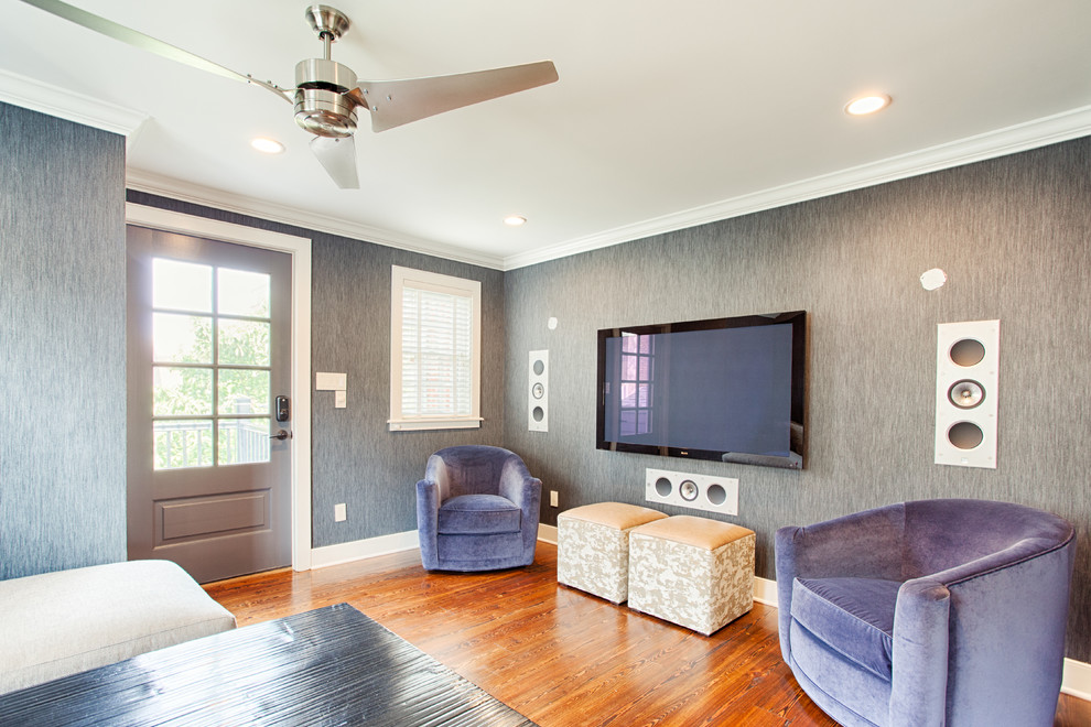 На фото: изолированная гостиная комната среднего размера в стиле модернизм с серыми стенами, темным паркетным полом и телевизором на стене с